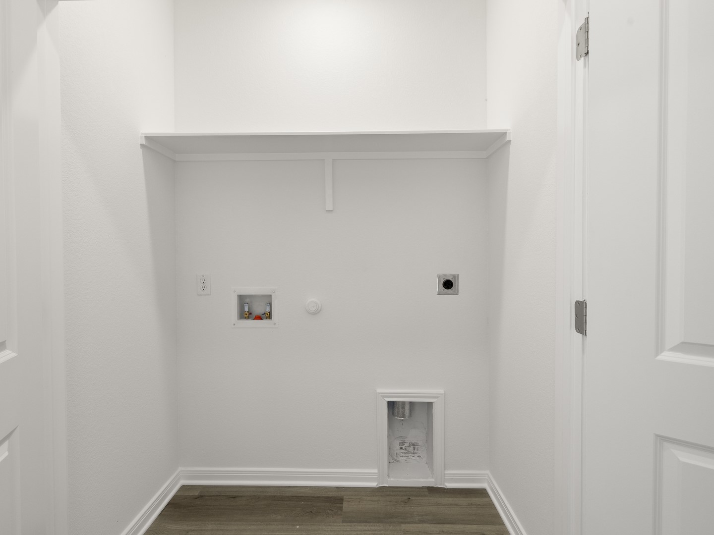 513 Yellow Ribbon Trail Jarrell, TX 76537 - Photo 15 of 23 A dedicated laundry alcove with convenient hookups and a practical storage shelf.