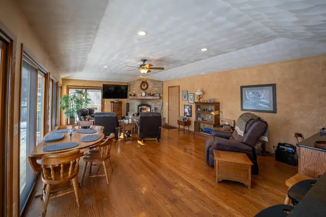 a dining room with furniture and wooden floor