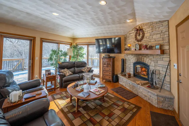 a view of a workspace with furniture and wooden floor