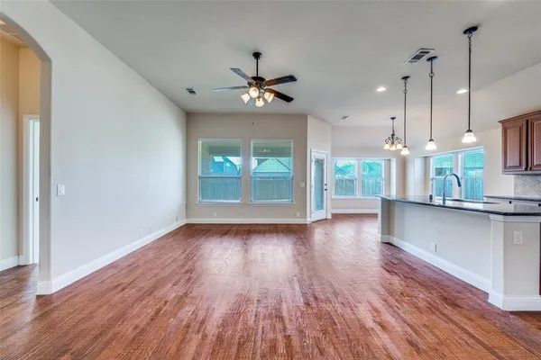 a view of a kitchen with wooden floor and a kitchen