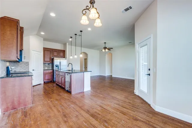 a view of kitchen with cabinets and wooden floor