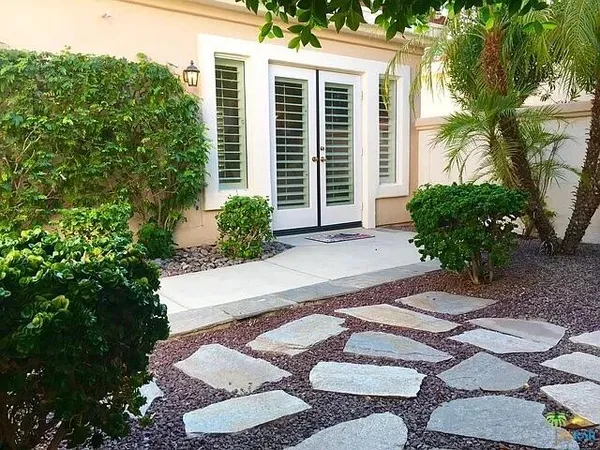 a view of a bedroom with furniture and windows