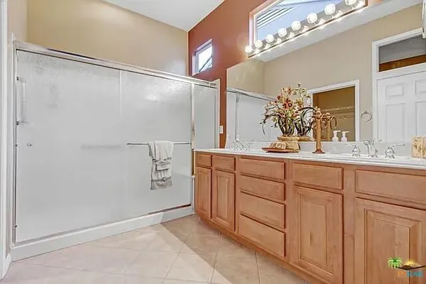 a bathroom with a double vanity sink and a mirror