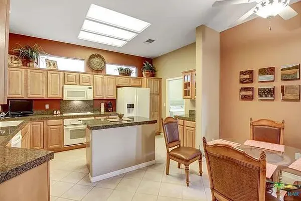a kitchen with stainless steel appliances granite countertop sink stove and refrigerator