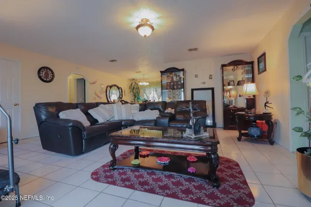 a kitchen with stainless steel appliances granite countertop a sink a stove a microwave a refrigerator and cabinets