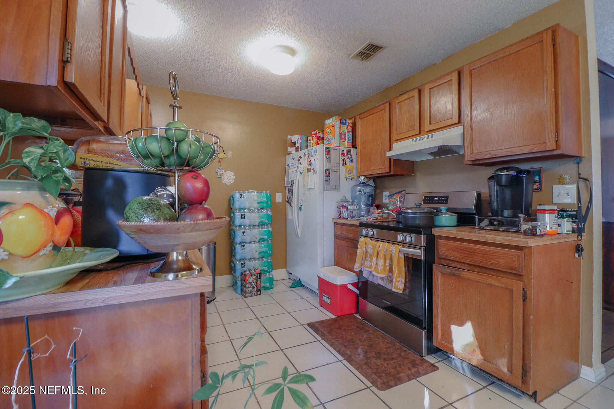 2847 Homestead Road Orange Park, FL 32065 - Photo 18 of 26 a kitchen with stainless steel appliances granite countertop a sink a stove a microwave a refrigerator and cabinets