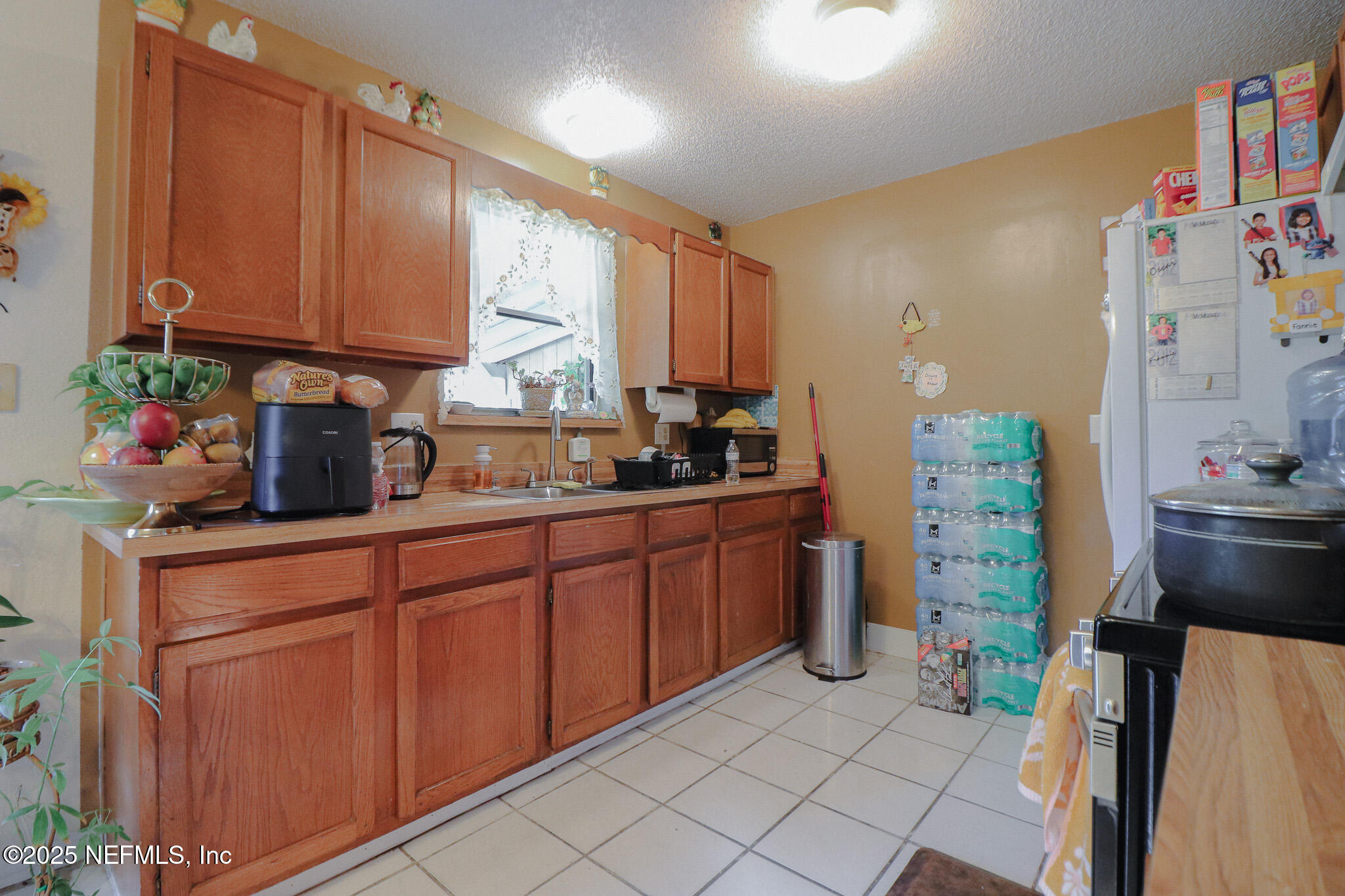 2847 Homestead Road Orange Park, FL 32065 - Photo 19 of 26 a kitchen with stainless steel appliances a sink cabinets and a window
