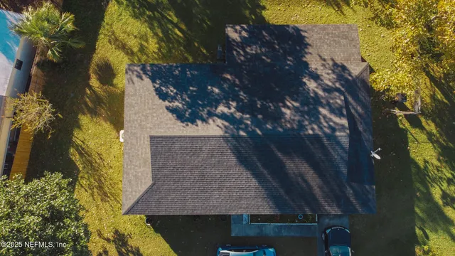an aerial view of a house with a lake view