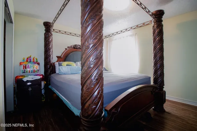 a bedroom with a bed and a chandelier