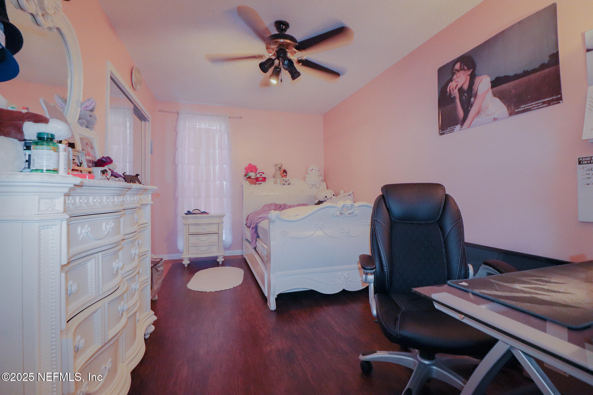 2847 Homestead Road Orange Park, FL 32065 - Photo 23 of 26 a bedroom with a bed and a chandelier
