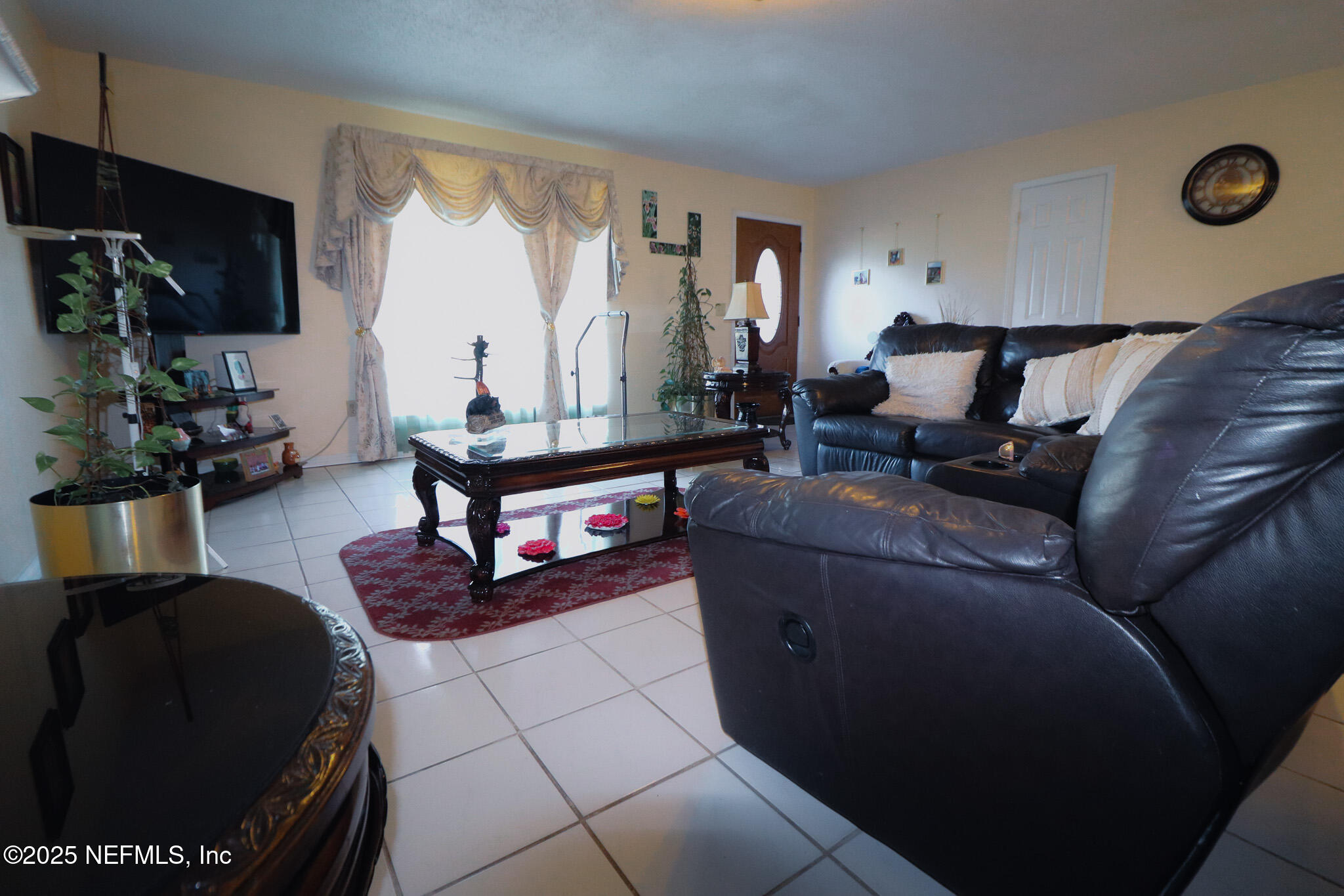2847 Homestead Road Orange Park, FL 32065 - Photo 26 of 26 a living room with furniture and a flat screen tv