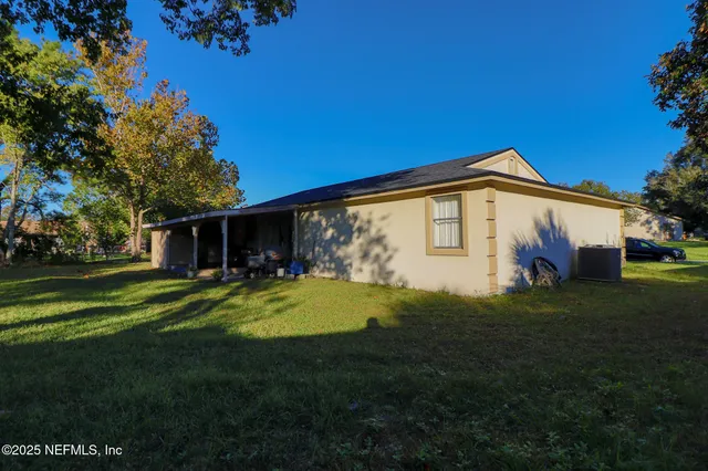 a view of a house with a yard porch and sitting area