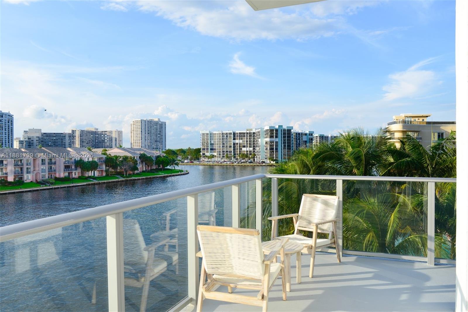 4010 South Ocean Drive, Unit R302 Hollywood, FL 33019 - Photo 1 of 34 a view of a chairs and table on wooden deck with city view