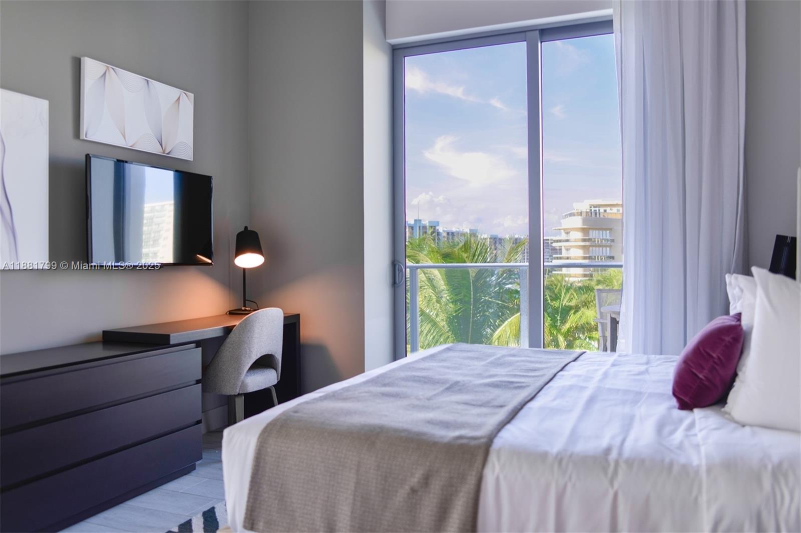4010 South Ocean Drive, Unit R302 Hollywood, FL 33019 - Photo 11 of 34 a bedroom with a bed and a dresser next to a window