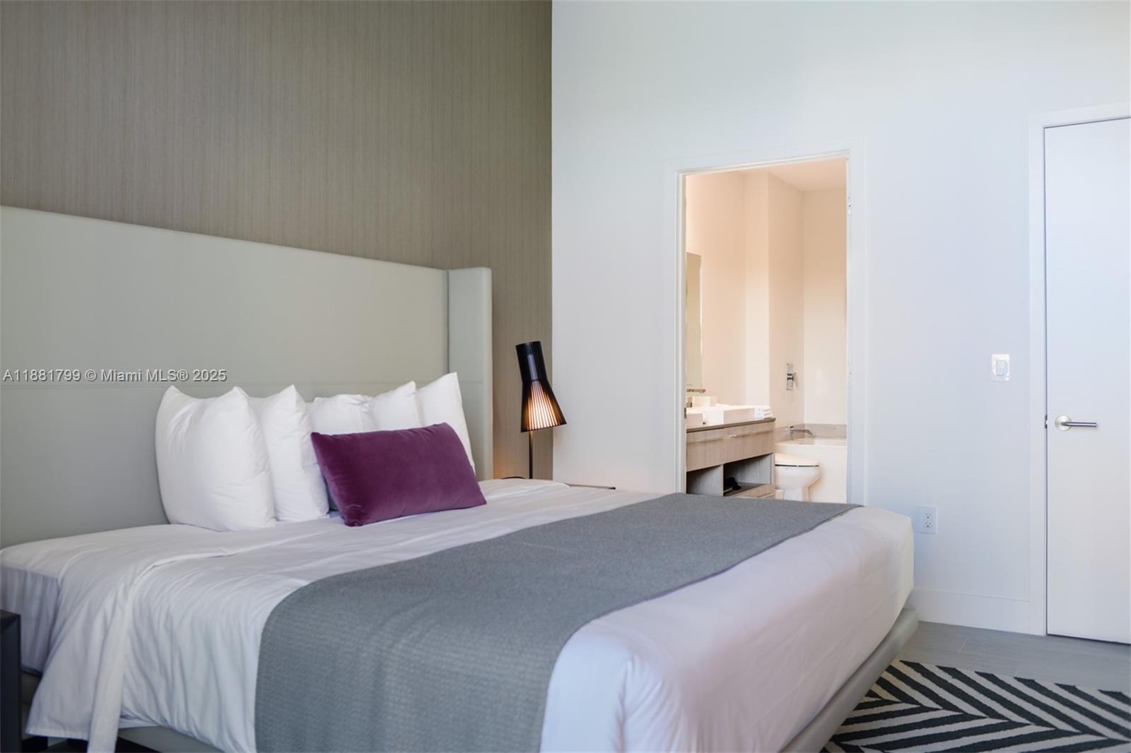 4010 South Ocean Drive, Unit R302 Hollywood, FL 33019 - Photo 12 of 34 a bedroom with a bed and a large mirror