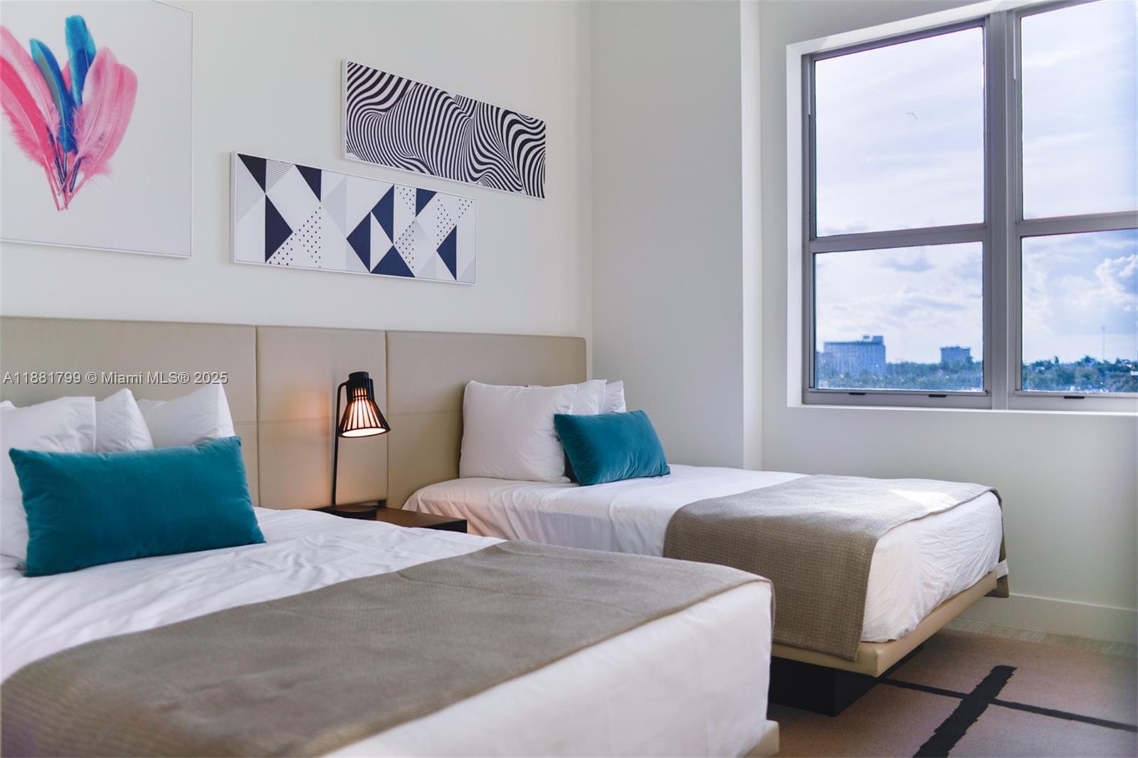 4010 South Ocean Drive, Unit R302 Hollywood, FL 33019 - Photo 13 of 34 a bedroom with two beds and a large window