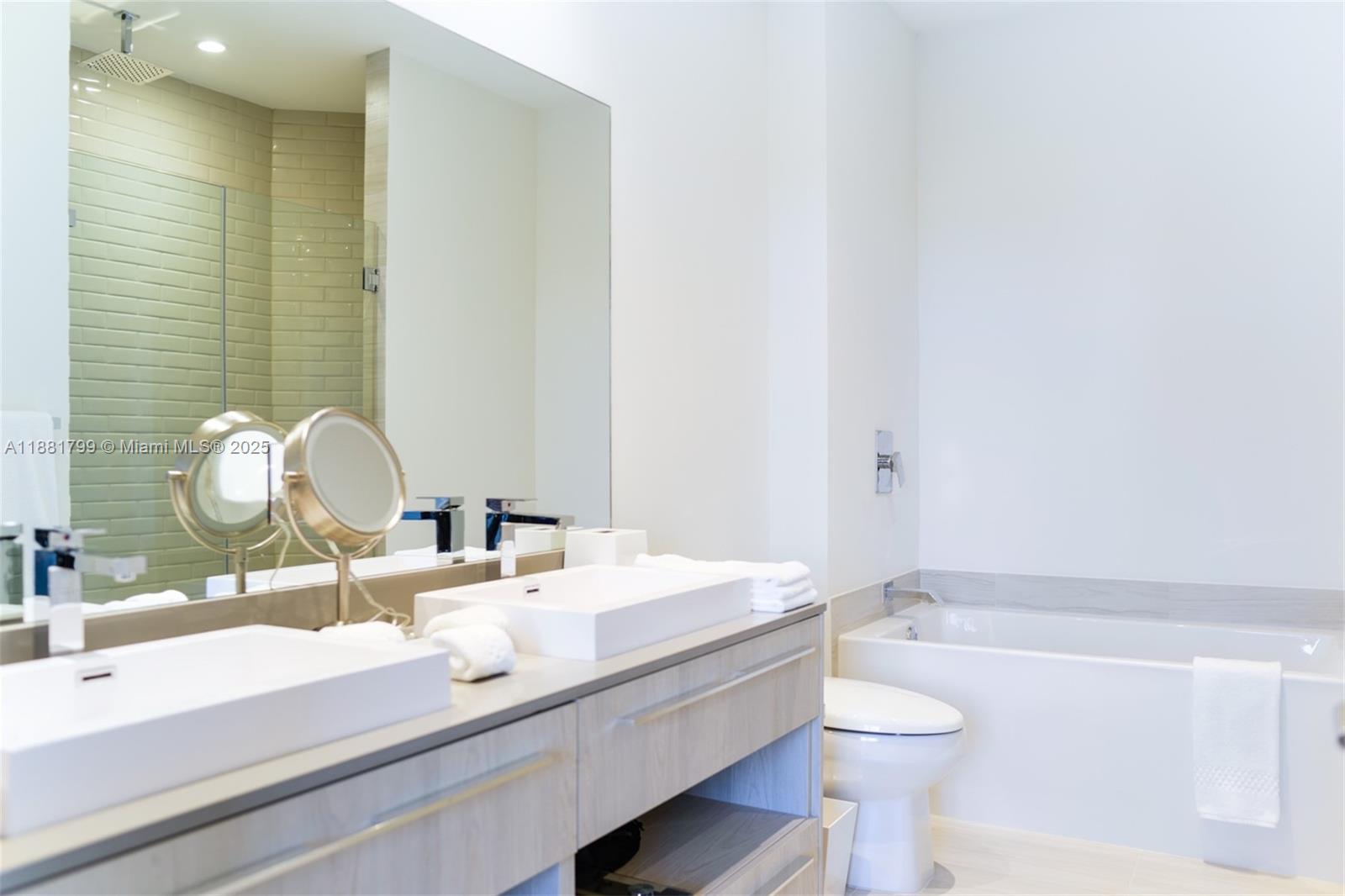 4010 South Ocean Drive, Unit R302 Hollywood, FL 33019 - Photo 14 of 34 a bathroom with a sink and a mirror