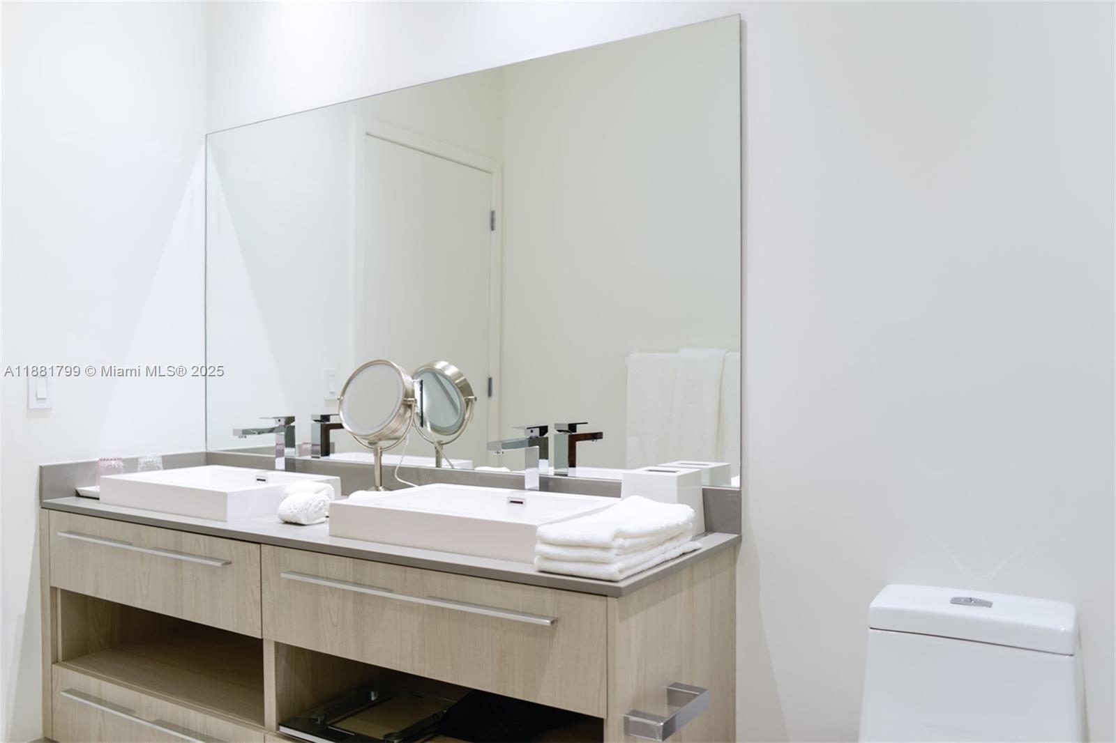 4010 South Ocean Drive, Unit R302 Hollywood, FL 33019 - Photo 15 of 34 a bathroom with a sink and a mirror