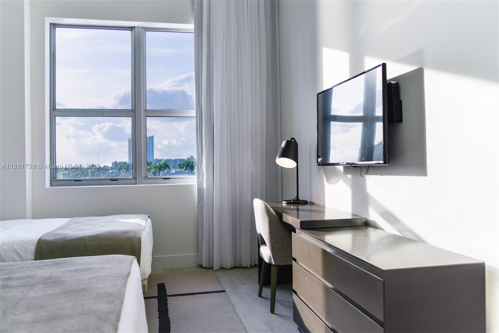 4010 South Ocean Drive, Unit R302 Hollywood, FL 33019 - Photo 19 of 34 a bedroom with a bed and a dresser