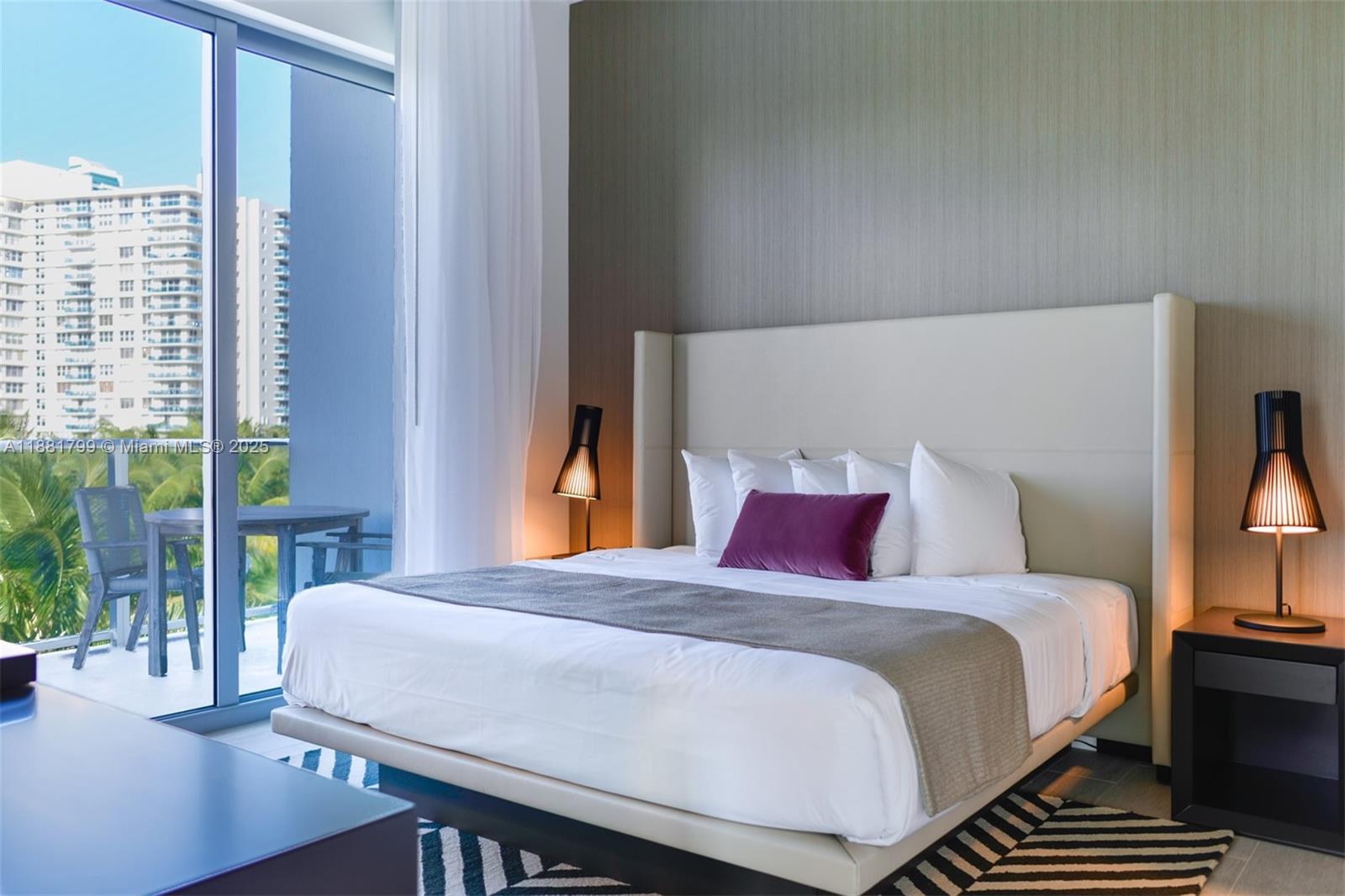 4010 South Ocean Drive, Unit R302 Hollywood, FL 33019 - Photo 10 of 34 a bed sitting in a bedroom next to a window