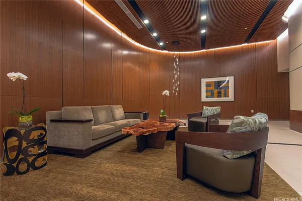 a living room with furniture and a potted plant