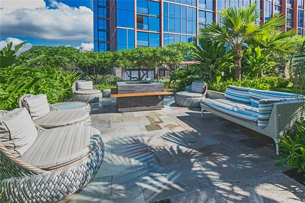 a view of a patio with couches table and chairs and potted plants
