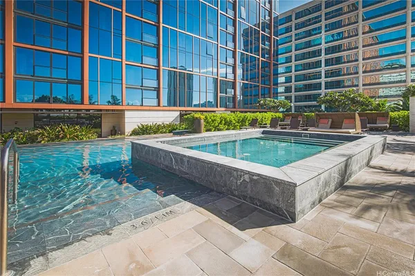 a view of a swimming pool with a lounge chairs