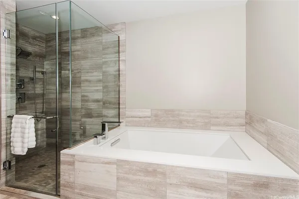 a bathroom with a bathtub and shower