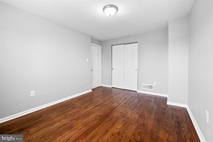 631 Charraway Road Baltimore, MD 21229 - Photo 13 of 25 a view of an empty room with wooden floor