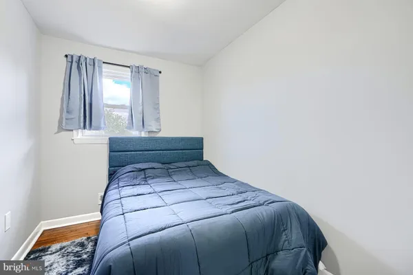 a bed sitting in a bedroom next to a window