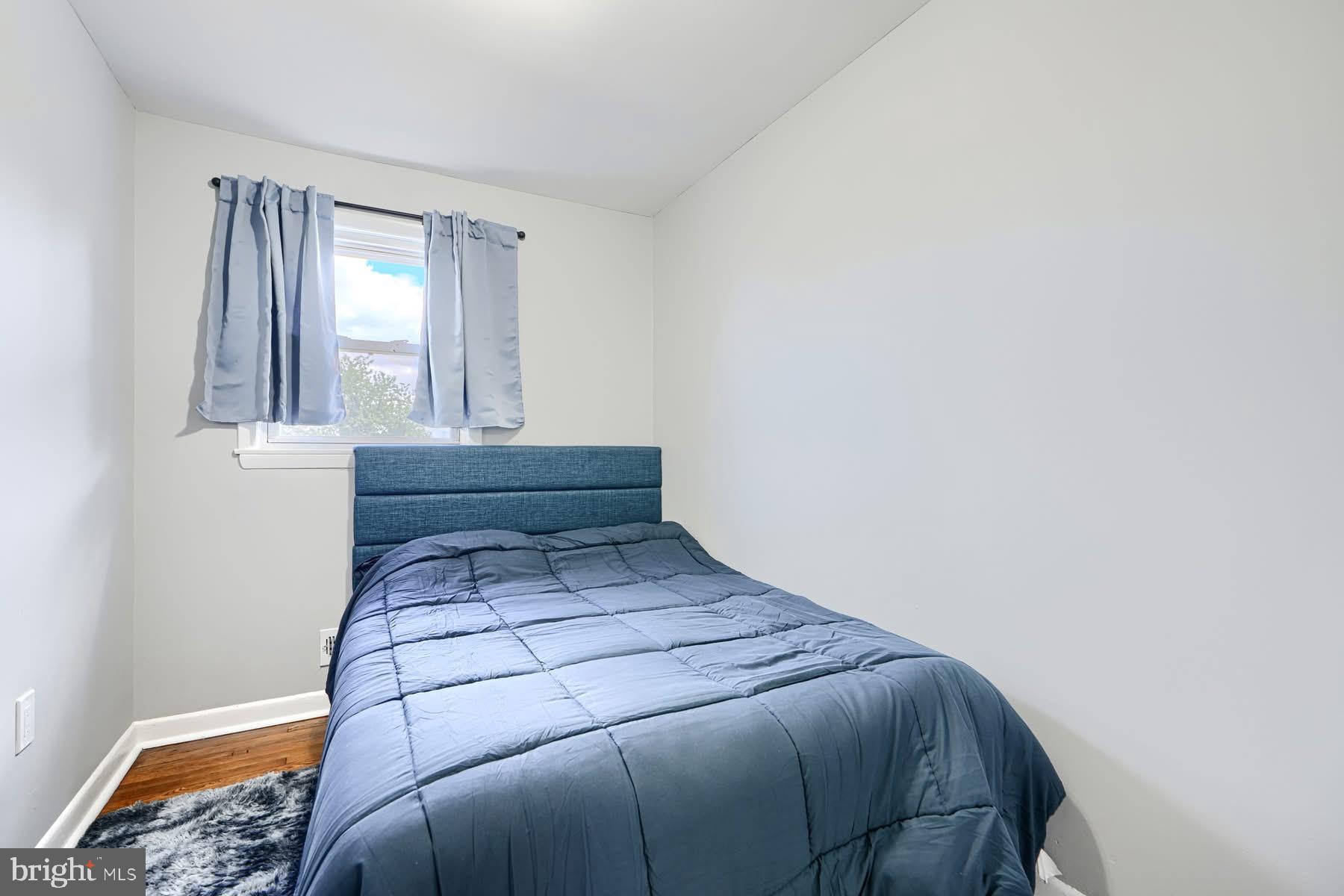 631 Charraway Road Baltimore, MD 21229 - Photo 14 of 25 a bed sitting in a bedroom next to a window