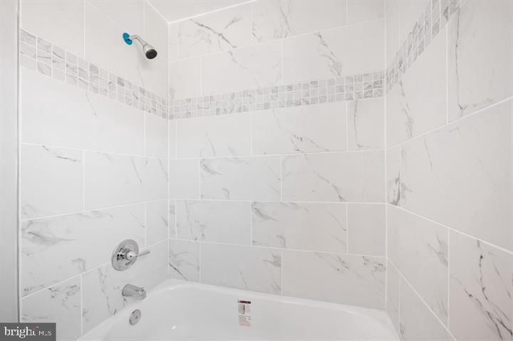 631 Charraway Road Baltimore, MD 21229 - Photo 18 of 25 a bathroom with a bathtub and shower