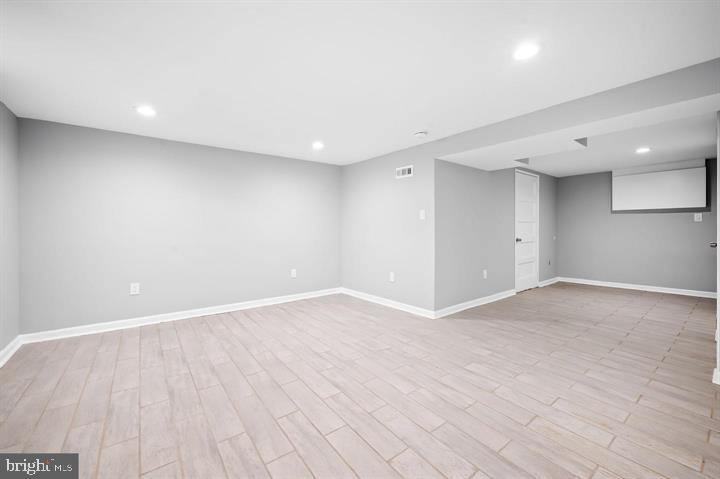 631 Charraway Road Baltimore, MD 21229 - Photo 19 of 25 a view of an empty room with wooden floor