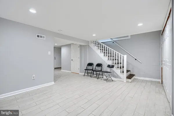a view of entryway and hall with wooden floor