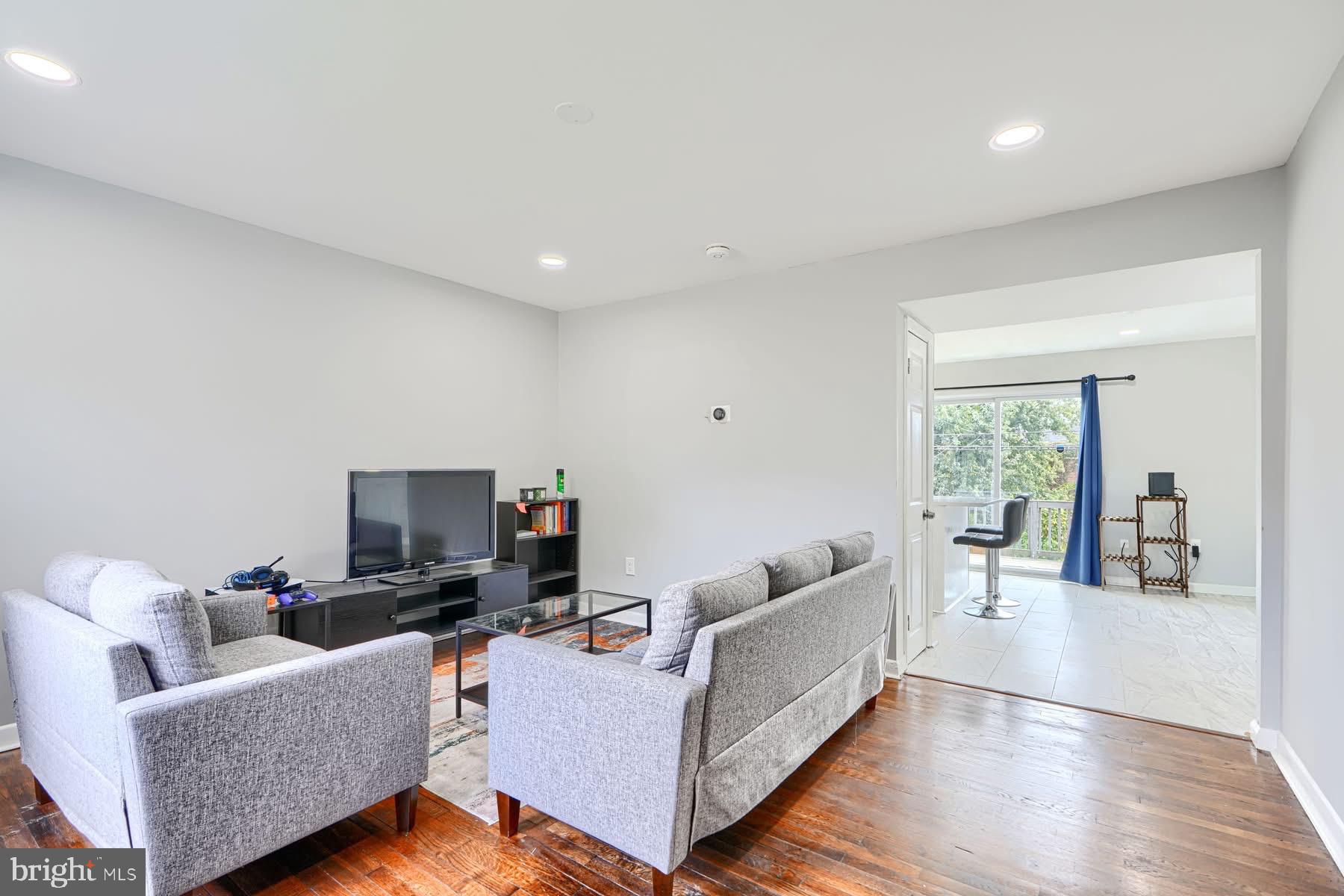 631 Charraway Road Baltimore, MD 21229 - Photo 2 of 25 a living room with furniture and a flat screen tv