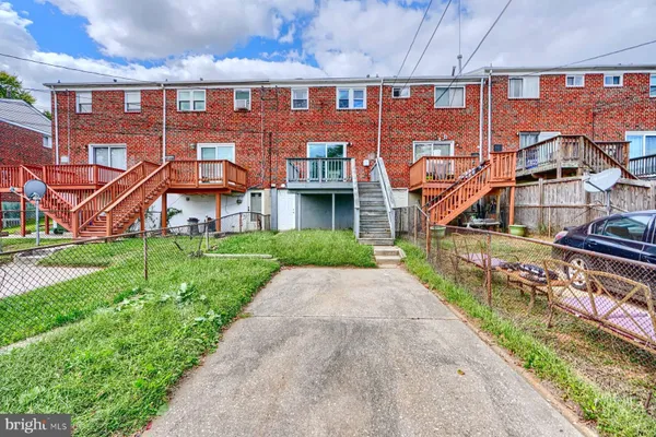 front view of a brick building with a yard