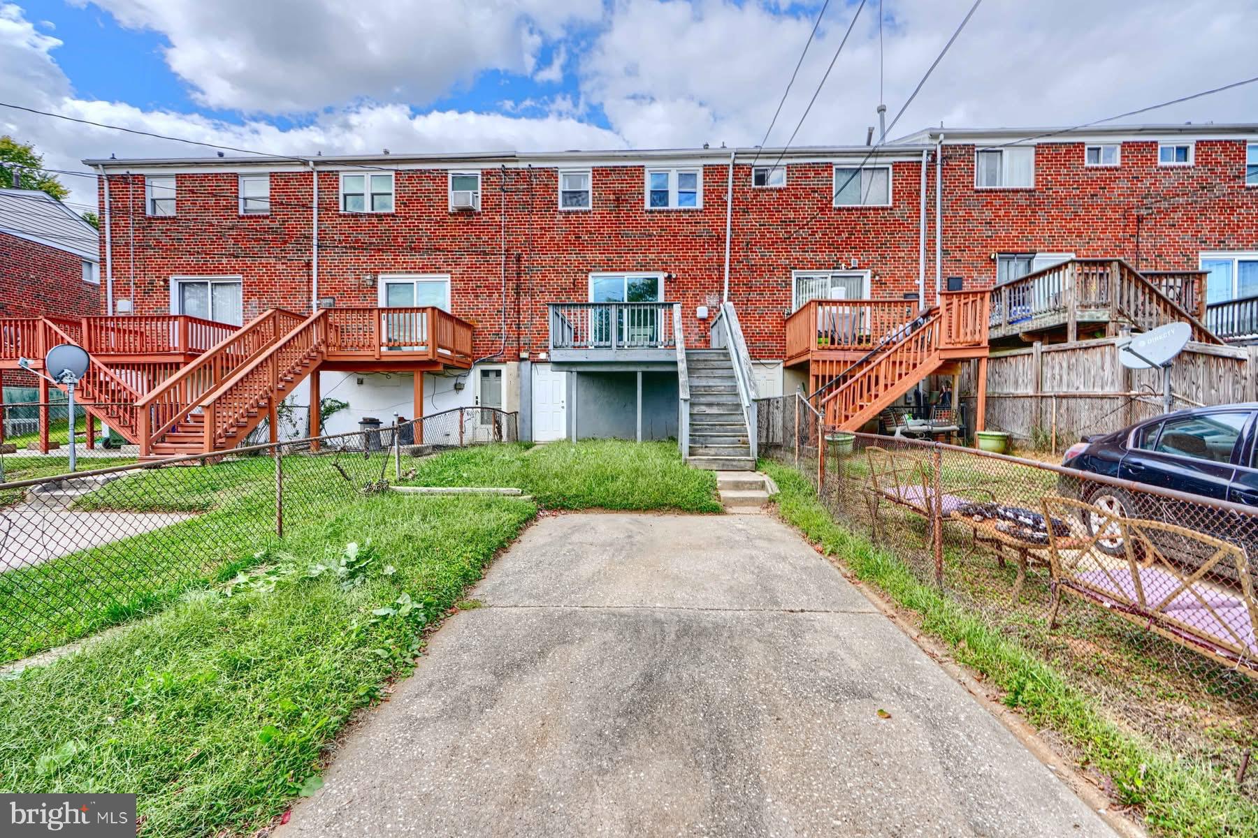 631 Charraway Road Baltimore, MD 21229 - Photo 24 of 25 front view of a brick building with a yard