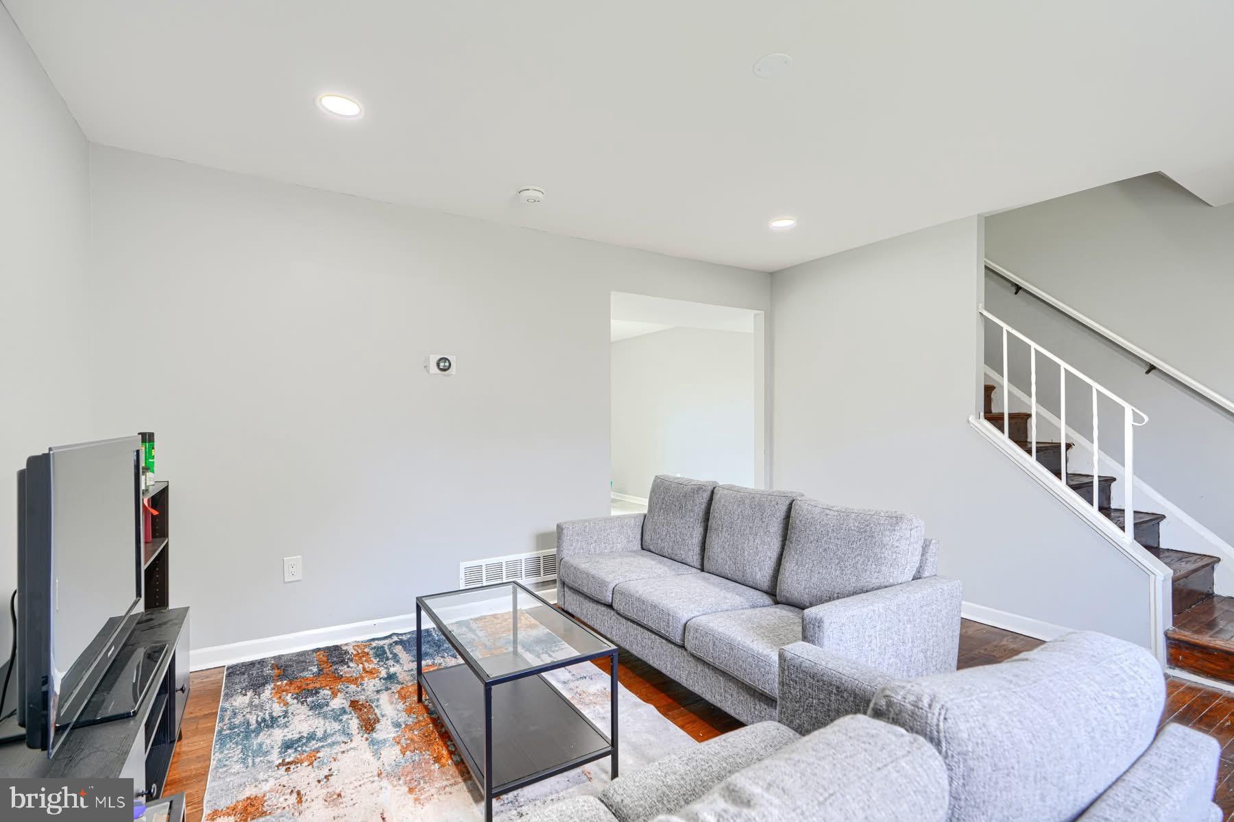 631 Charraway Road Baltimore, MD 21229 - Photo 3 of 25 a living room with furniture and a flat screen tv