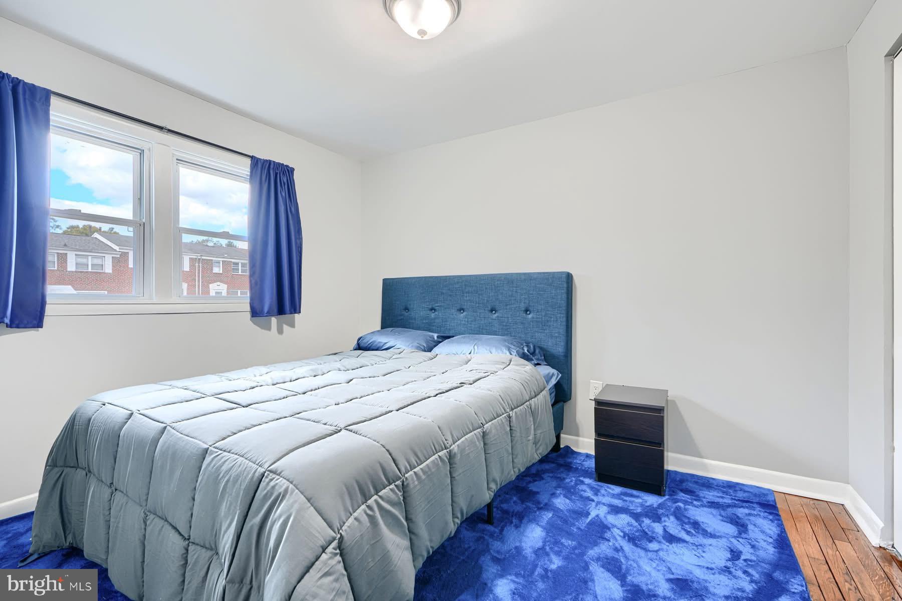 631 Charraway Road Baltimore, MD 21229 - Photo 8 of 25 a bed sitting in a bedroom next to a window