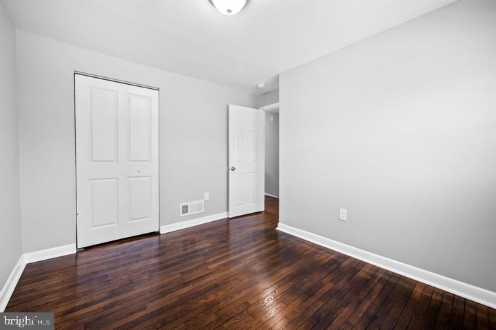 631 Charraway Road Baltimore, MD 21229 - Photo 10 of 25 a view of an empty room with wooden floor