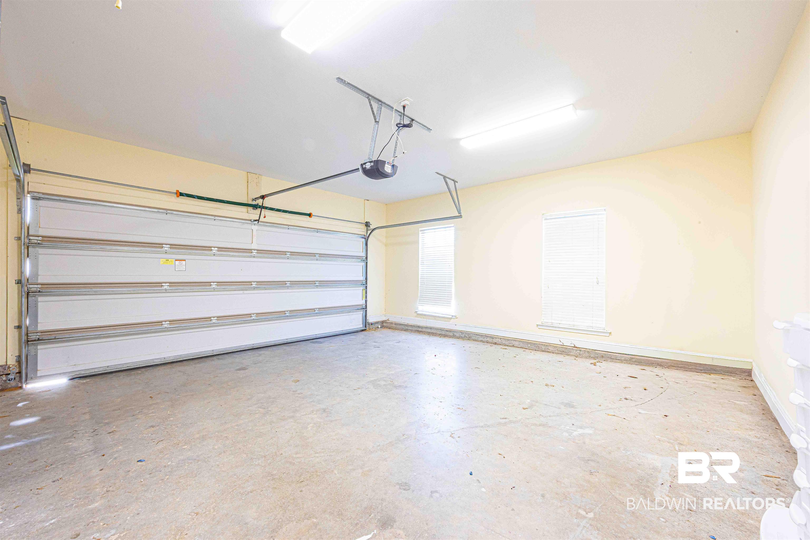 25234 Fairfax Road Daphne, AL 36526 - Photo 31 of 45 Garage with baseboards and a garage door opener