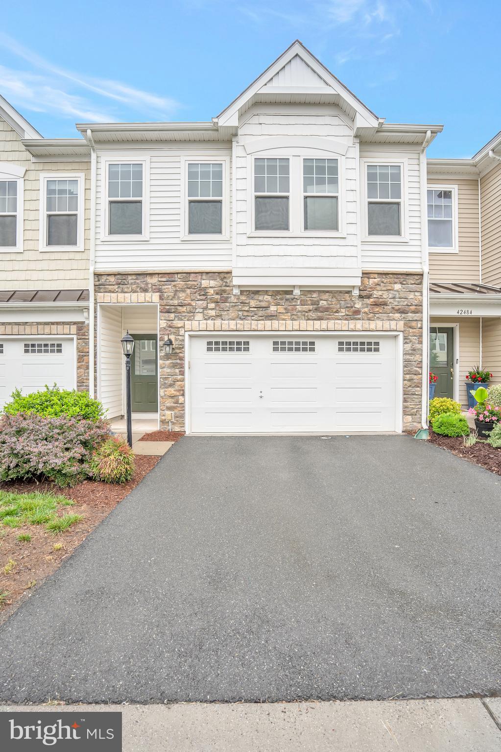 42482 Benfold Square Ashburn, VA 20148 - Photo 26 of 34 a front view of a house with a yard and garage