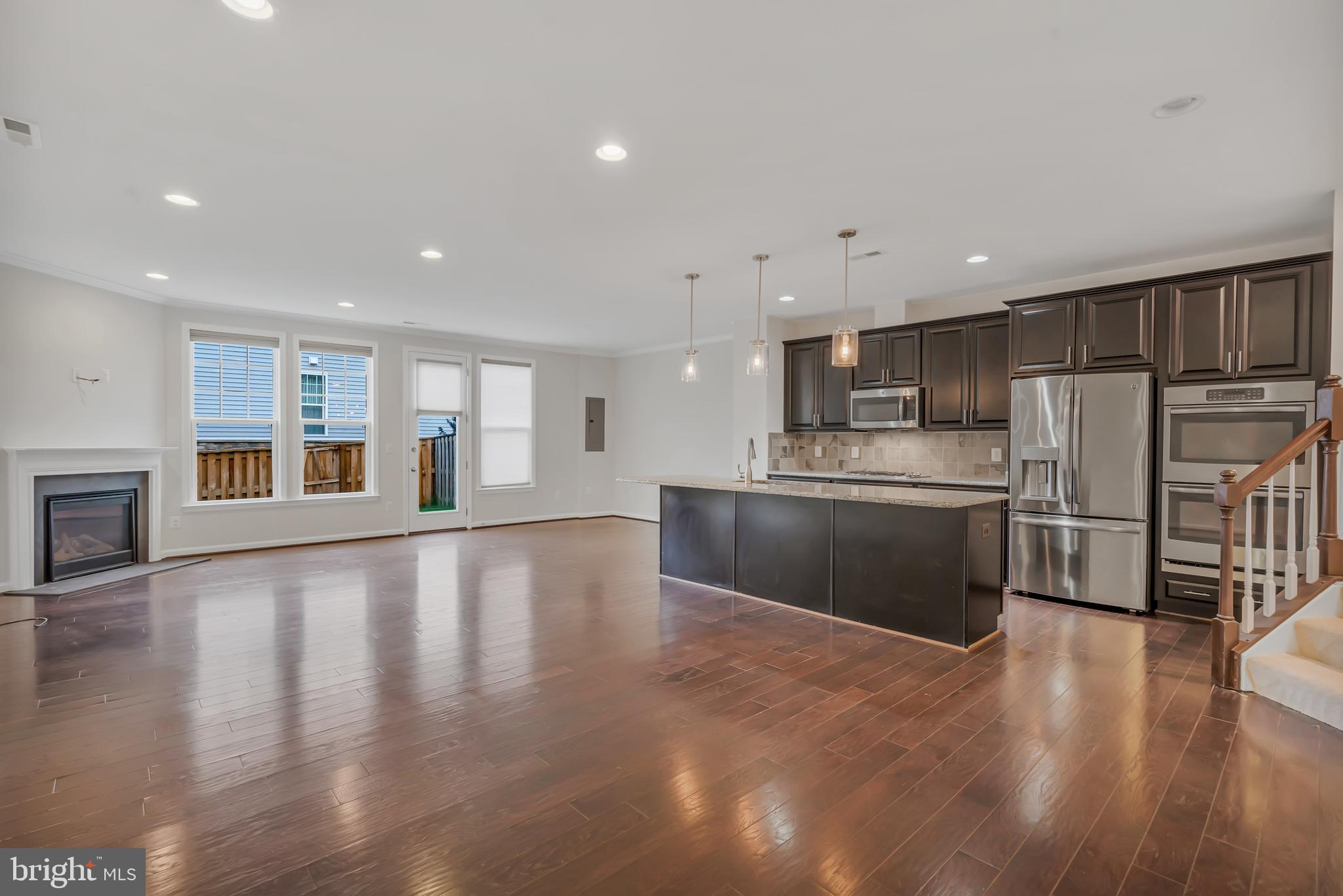 42482 Benfold Square Ashburn, VA 20148 - Photo 5 of 34 a kitchen with stainless steel appliances granite countertop a refrigerator sink and stove
