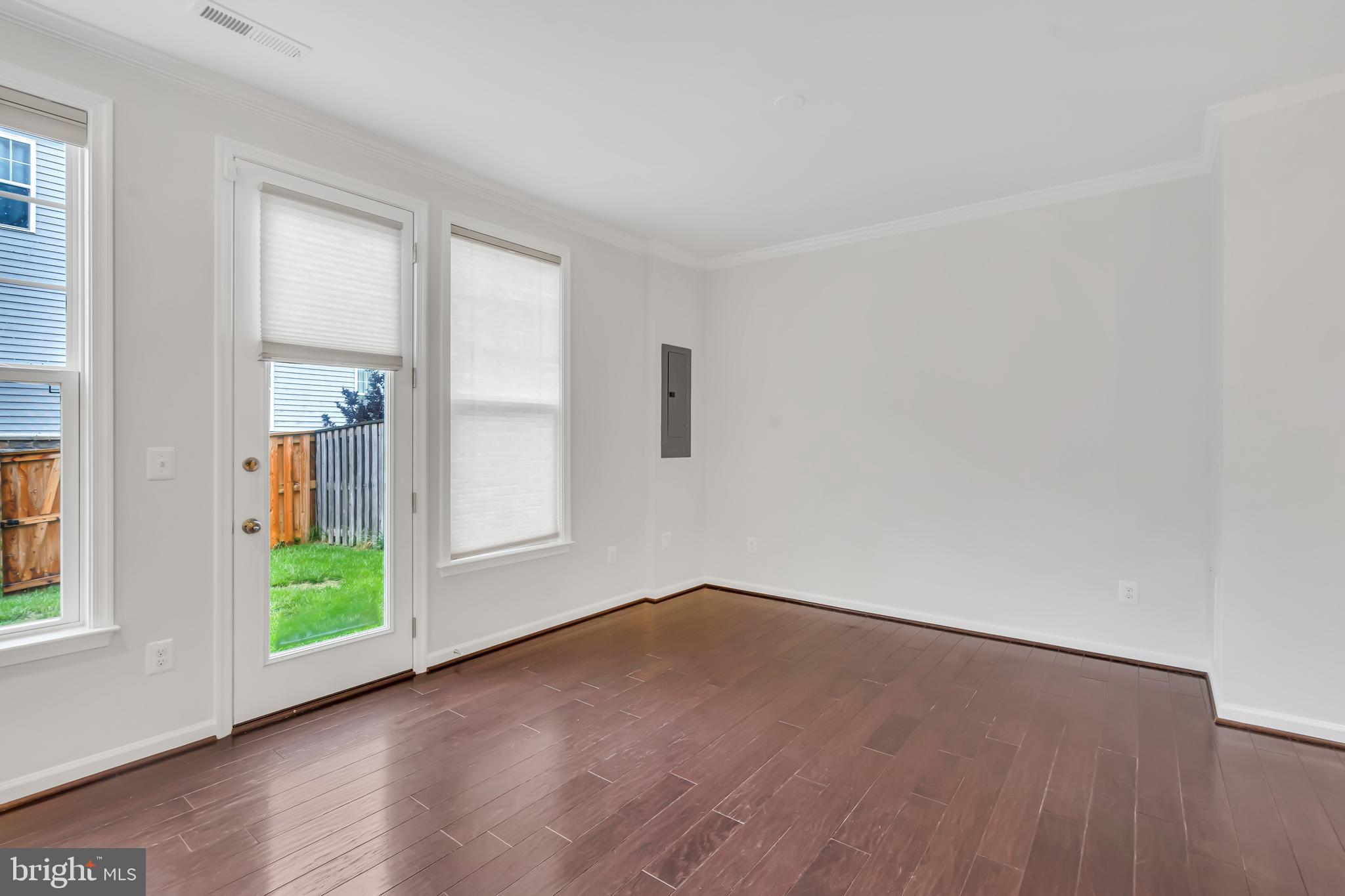 42482 Benfold Square Ashburn, VA 20148 - Photo 8 of 34 a view of an empty room with wooden floor and a window