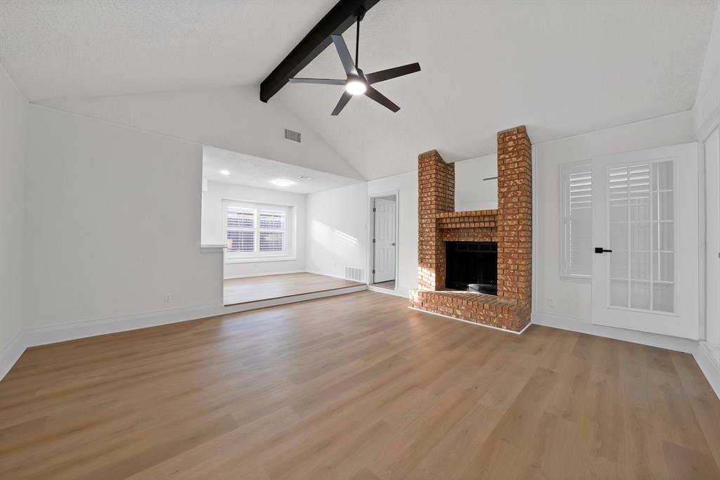 825 Meadowdale Road Arlington, TX 76017 - Photo 1 of 19 a view of an empty room with wooden floor fireplace and a window