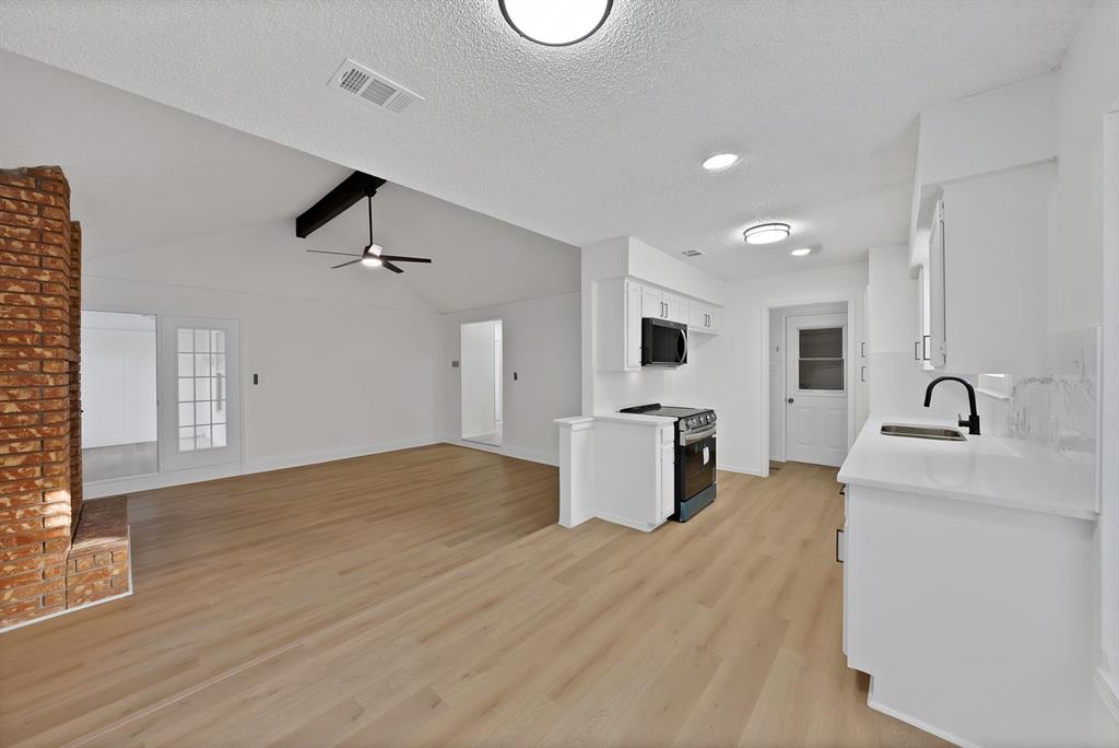 825 Meadowdale Road Arlington, TX 76017 - Photo 2 of 19 a kitchen with stainless steel appliances kitchen island a sink a stove and cabinets