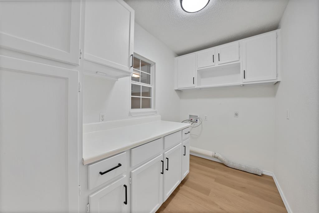 825 Meadowdale Road Arlington, TX 76017 - Photo 5 of 19 a kitchen with white cabinets and window