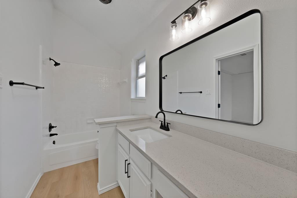 825 Meadowdale Road Arlington, TX 76017 - Photo 10 of 19 a bathroom with a sink and a mirror