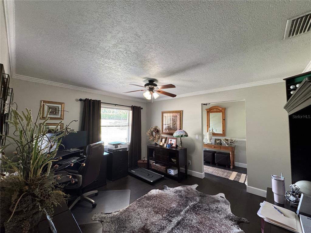 334 West F Street Frostproof, FL 33843 - Photo 11 of 48 a living room with furniture a chandelier and a flat screen tv