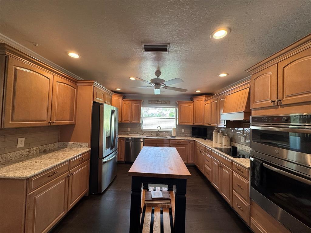 334 West F Street Frostproof, FL 33843 - Photo 13 of 48 a kitchen with a sink stainless steel appliances and window